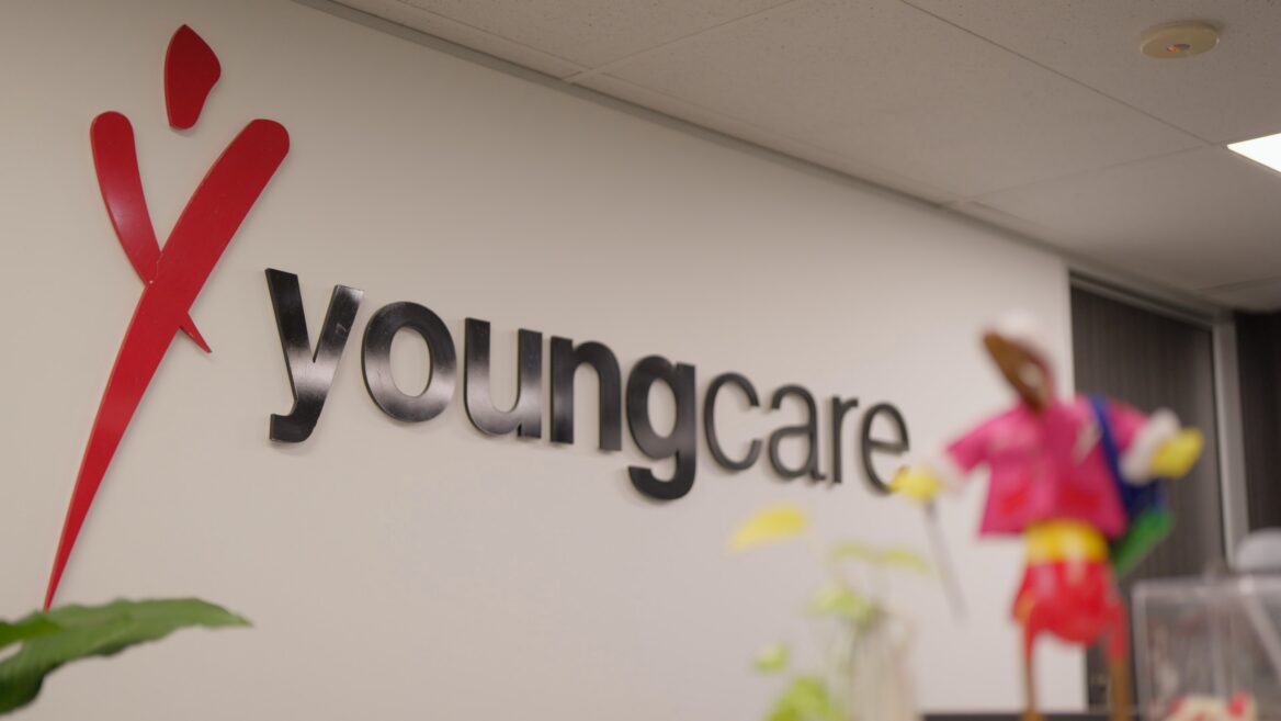 Youngcare sign on a white office wall