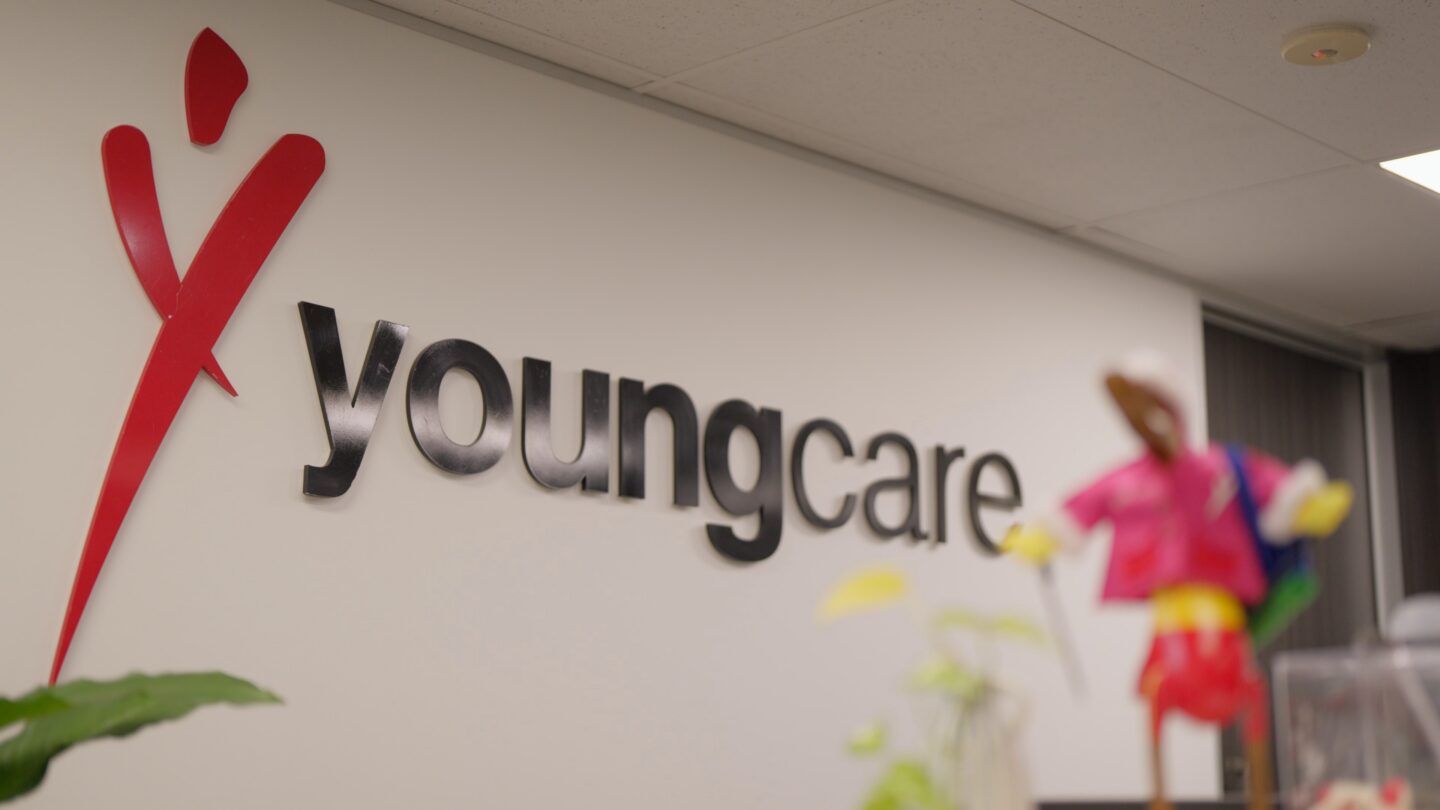 Youngcare sign on a white office wall