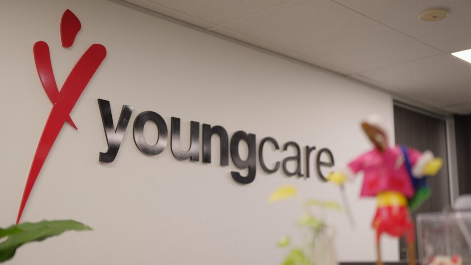 Youngcare sign on a white office wall