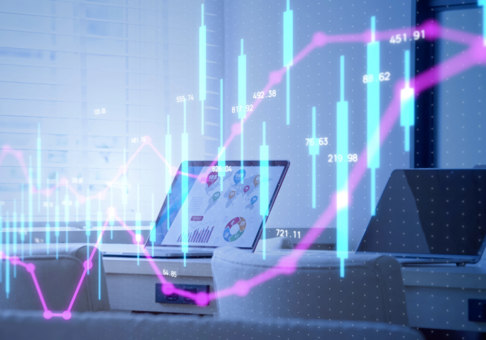 A desk with two laptop screens, on with a map and some graphs and data visualisations on the screen, data visualisations also displayed in the foreground
