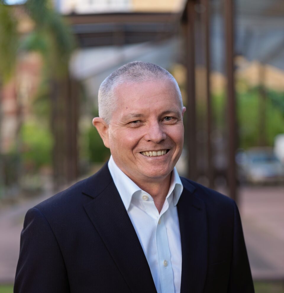 Louis Hof Headshot - Louis wears a dark jacket and white shirt