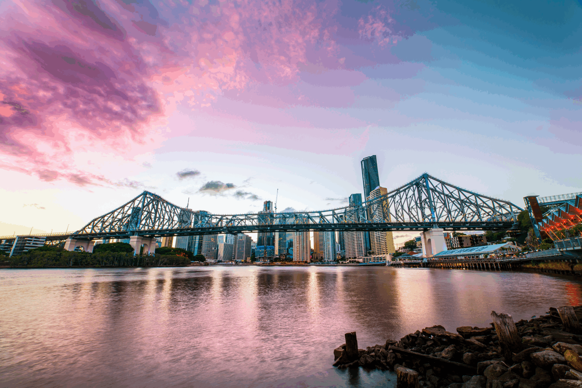 Sky scape of brisbane cbd, with the story bridge and a vibrant sunset.