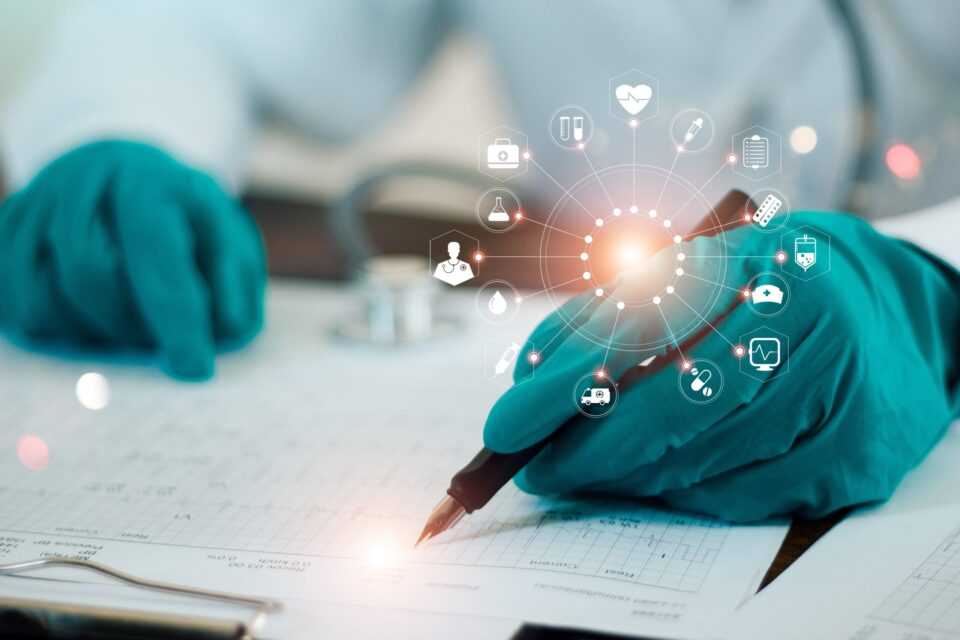 A hand with a spandex glove writing notes with icons including doctors, needles, ambulance, medical supplies etc
