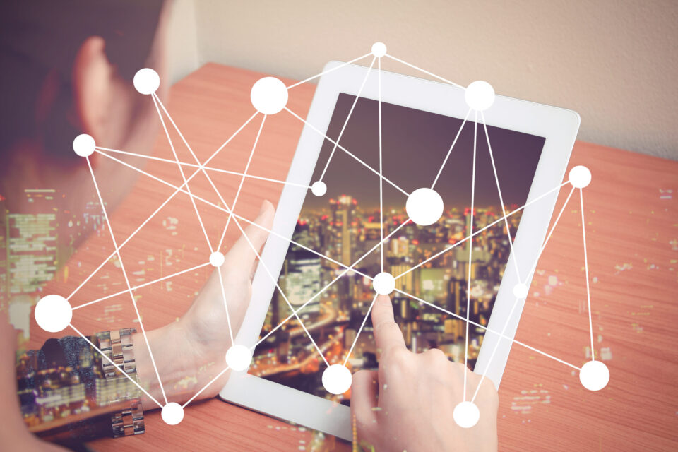 tablet with city scape and connectivity icon in foreground